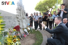 US Ambassador to Vietnam Daniel J. Kritenbrink pays tribute before a sculpture depicting the capture the then-US Navy pilot John McCain whose fighter jet was shot down in 1967, near Truc Bach lake in Hanoi on August 27, 2018.