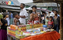 In this photograph taken Aug. 27, 2018, a Rohingya man looks at medicines being sold on the roadside in Balukhali refugee camp, Bangladesh. (AP Photo/Altaf Qadri)