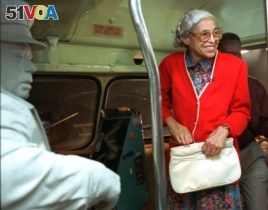 FILE - Rosa Parks visits an exhibit illustrating her bus ride of December, 1955 at the National Civil Rights Museum in Memphis, Tennessee, July 15, 1995.