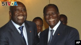 FILE - Former Ivory Coast President Laurent Gbagbo, left, and incumbent Alassane Ouattara posed for a photo before the 2010 ballot.
