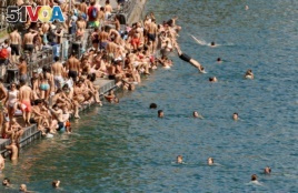 People swim during hot summer weather in the Limmat river in Zurich, Switzerland July 1, 2018.