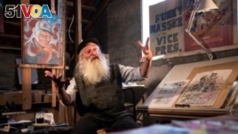 Michael Netzer, an American comics artist formerly named Mike Nasser, gestures during his interview with Reuters at his attic studio in his home in the Jewish settlement of Ofra in the Israeli-occupied West Bank