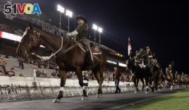 The Texas A&M Corps of Cadets Parsons Mounted Calvary enters a stadium before a college football game, 2010, Texas. (AP Photo/David J. Phillip)