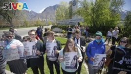 Protesters stand in solidarity with rape victims on the campus of Brigham Young University during a sexual assault awareness demonstration, in Provo, Utah.