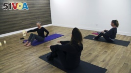 In this January 16, 2019 photo, writer and editor Camille LeFevre, left, leads a pilates work at ModernWell in Minneapolis.