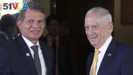 Brazil's Defense Minister Joaquim Silva e Luna, left, and U.S. Secretary of Defense Jim Mattis, smile as they pose for photos after their meeting in Brasilia, Brazil, Monday, Aug. 13, 2018. 