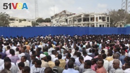 Thousands of Somalis gather to pray at the site of the country's deadliest attack and to mourn the hundreds of victims, at the site of the attack in Mogadishu, Somalia, Oct. 20, 2017.