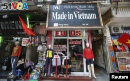Vendors sit outside a shop selling clothes in Hanoi. Vietnam is seeking trade teals with a number of countries.
