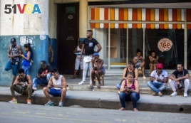 In this Jan. 6, 2017 photo, people use a public wifi hotspot in Havana, Cuba. Home internet came to Cuba in December 2016, in a limited pilot program