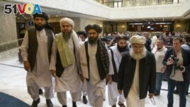 FILE - In this May 28, 2019 file photo, Mullah Abdul Ghani Baradar, the Taliban group's top political leader, third from left, arrives with other members of the Taliban delegation for talks in Moscow, Russia. U.S. envoy Zalmay Khalilzad and the Taliban ha