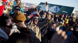 A crowd gathers in celebration at the Oceti Sakowin camp after it was announced that the U.S. Army Corps of Engineers won't grant easement for the Dakota Access oil pipeline in Cannon Ball, N.D., Dec. 4, 2016.