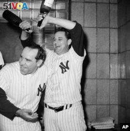 New York Yankees manager Yogi Berra gets a champagne shampoo from Pete Ramos after the Yanks clinched the American League Pennant by defeating Cleveland, 8-3, Oct. 3, 1964.