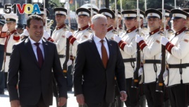 U.S. Defense Secretary James Mattis, center, and Macedonian Prime Minister Zoran Zaev walk past an honor guard at the government building in Skopje, Macedonia, Sept. 17, 2018. (AP Photo/Boris Grdanoski)