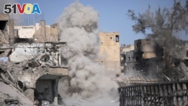 Smoke rises after a landmine exploded as fighters of Syrian Democratic Forces are clearing roads after liberation of Raqqa, Syria Oct. 18, 2017.