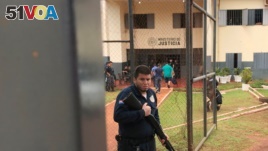 A guard is seen at the border prison, where prisoners, housed in a gallery for members of Brazil's First Capital Command (PCC) gang, broke out of the jail in Pedro Juan Caballero, Paraguay January 22, 2020. Picture taken January 22, 2020. REUTERS/Gabriel 