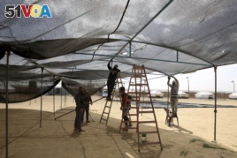 eople set up a large tent in preparation for mass demonstrations along the Gaza strip border with Israel, east of Khan Younis, Thursday, March 29, 2018. (AP Photo/Adel Hana)