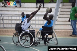 A wheelchair basketball player tries to block a pass by an opponent at a basketball court in Juba, South Sudan, May 24, 2016.