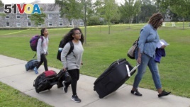 First generation college student Minori Kawano, of New York, center, arrives at Middlebury College accompanied by her mother, Mercy Kawano, right, and younger sister Mayomi Kawano, left. The school is among a number of colleges with programs to help ease the transition to college for students who are the first in their families to attend. (AP Photo/Wilson Ring)