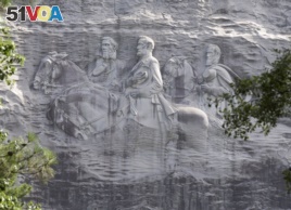 FILE - This June 23, 2015, file photo shows a carving depicting confederates Stonewall Jackson, Robert E. Lee and Jefferson Davis, in Stone Mountain, Ga.