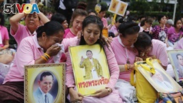Thais cry as they pray for Thailand's King Bhumibol Adulyadej at Siriraj Hospital where the king is being treated in Bangkok, Thailand, Oct. 13, 2016.