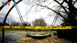 A children's playground is closed with caution tape amid the coronavirus disease (COVID-19) outbreak in Seattle, Washington, U.S., March 24, 2020. (REUTERS/Brian Snyder)