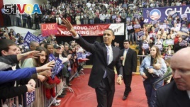 Democratic presidential hopeful Sen. Barack Obama, D-Ill., waves to the crowd as he arrives at a rally Monday, Feb. 18, 2008, in Youngstown, Ohio. (AP Photo/Rick Bowmer)
