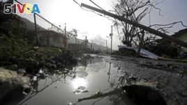 Downed power lines and debris are seen in the aftermath of Hurricane Maria in Yabucoa, Puerto Rico, Sept. 26, 2017.