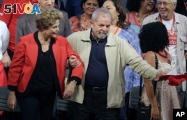FILE -  In this Oct.13, 2015 file photo, Brazil's former President Luiz Inacio Lula da Silva, right, and current President Dilma Rousseff, attend the Central Workers Union annual convention in Sao Paulo, Brazil. The Brazilian government's leader in the lower house of Congress said Wednesday, March 16, 2016, that Silva has been named chief of staff to Rousseff. It's a move that could help Silva avoid possible detention in expanding corruption probes that have now touched the top of Brazil's political leadership. (AP Photo/Nelson Antoine, File)