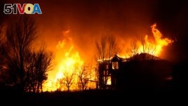 Homes burn as wildfires rip through a housing development, Dec. 30, 2021, in Superior, Colorado.
