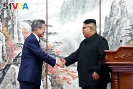 South Korean President Moon Jae-in shakes hands with North Korean leader Kim Jong Un after joint news conference in Pyongyang, North Korea, September 19, 2018.