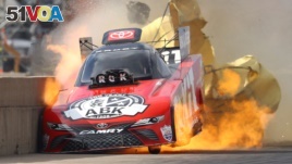 In Texas, race car driver Alexis DeJoria suffers an engine fire after winning her first-round matchup during the Fall Nationals at Texas Motorplex. She was uninjured in the fiery incident, Oct 18, 2020. (Mark J. Rebilas/USA TODAY Sports/Reuters)