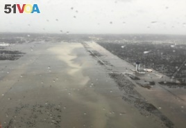 This Monday, Sept. 2, 2019 photo released by the U.S. Coast Guard Station Clearwater, shows flooding on the runway of the Marsh Harbour Airport in the Bahamas.
