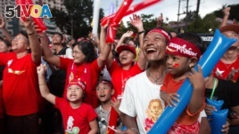 Supporters of Myanmar's National League for Democracy party cheer as election results are posted outside the NLD headquarters in Yangon, Myanmar, Monday, Nov. 9, 2015. (AP Photo/Mark Baker)