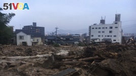Debris fills a small village following heavy rains Sunday, July 8, 2018, in Kuchita-Minami, Asakita-ku, Hiroshima, Japan. (AP Photo Haruka Nuga)