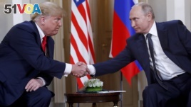 U.S. President Donald Trump, left, and Russian President Vladimir Putin, right, shake hand at the beginning of a meeting at the Presidential Palace in Helsinki, Finland, July 16, 2018. 