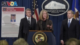 Acting Assistant Attorney General Mary McCord, center, announced charges against four defendants, including two officers of Russian security services, for a mega data breach at Yahoo. (AP Photo/Susan Walsh)