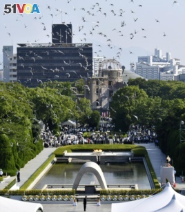 Doves fly over the Peace Memorial Park with the Atomic Bomb Dome in the background, at a ceremony in Hiroshima, western Japan, August 6, 2018, on the 73rd anniversary of the atomic bombing of the city. Mandatory credit Kyodo/via REUTERS