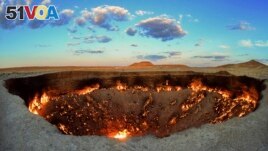 The crater fire named Gates of Hell is seen near Darvaza, Turkmenistan, Saturday, July 11, 2020. The president of Turkmenistan is calling for an end to one of the country's blazing desert natural gas crater. (AP Photo/Alexander Vershinin)
