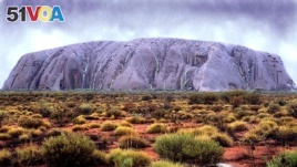 Ayers Rock (Uluru) takes on an unusual color as waterfalls cascade down its' walls in central Australia, Tuesday February 22, 2000 following the worst floods in the area for two decades. The rock which is usually a reddish colour is seldom seen like this.