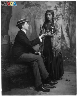A woman reads a man's fortune in his palm. These types of psychics are called 