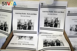 In this Wednesday, March 25, 2019, photo are learning guides to be distributed to students at John H. Webster Elementary School in Philadelphia. Only about half of the district's high school students have a laptop or tablet and home internet service. (AP)