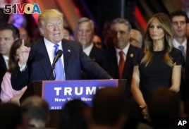 Republican presidential candidate Donald Trump speaks during a primary night news conference, Tuesday, April 26, 2016, in New York, as Melania Trump listens at right. (AP Photo/Julie Jacobson)