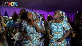 Some of the 106 girls who were kidnapped by Boko Haram militants in the Nigerian town of Chibok, are seen dancing joyfully during the the send-forth dinner organised for them in Abuja, Nigeria, Sept. 13, 2017.