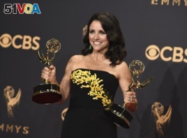 Julia Louis-Dreyfus poses in the press room with her awards for outstanding lead actress in a comedy series and outstanding comedy series for 