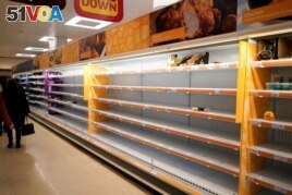 FILE - Shelves empty of fresh chicken in a supermarket, as the number of worldwide coronavirus cases continues to grow, in London, Britain, March 15, 2020. REUTERS/Henry Nicholls/File Photo