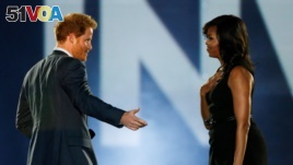 Britain's Prince Harry (L) and U.S. First Lady Michelle Obama take part in the opening ceremonies of the Invictus Games in Orlando, Florida, U.S., May 8, 2016.