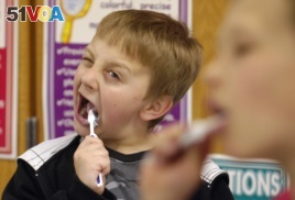 FILE: David Taylor, 9, gets into brushing his teeth after lunch in Moscow, Idaho, as part of a program started by Dentist Rich Bailey to help promote dental health. March 12, 2010.