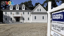 In this Sept. 3, 2019, photo a sign rests in front of a newly constructed home, in Westwood, Mass. America's new homes are much larger than they used to be. (AP Photo/Steven Senne)