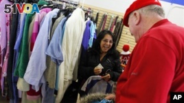 In this 2012 file photo, a shopper looking for clothes at the Salvation Army store in Staten Island, New York, receives a surprise $100 donation.