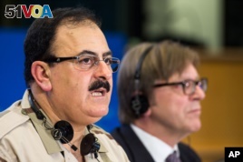 Chief of Staff of the Free Syrian Army Gen. Salim Idris addresses the media after he discussed the situation in Syria with the leader of the Group of the Alliance of Liberals and Democrats for Europe Guy Verhofstadt, right, at the European Parliament.